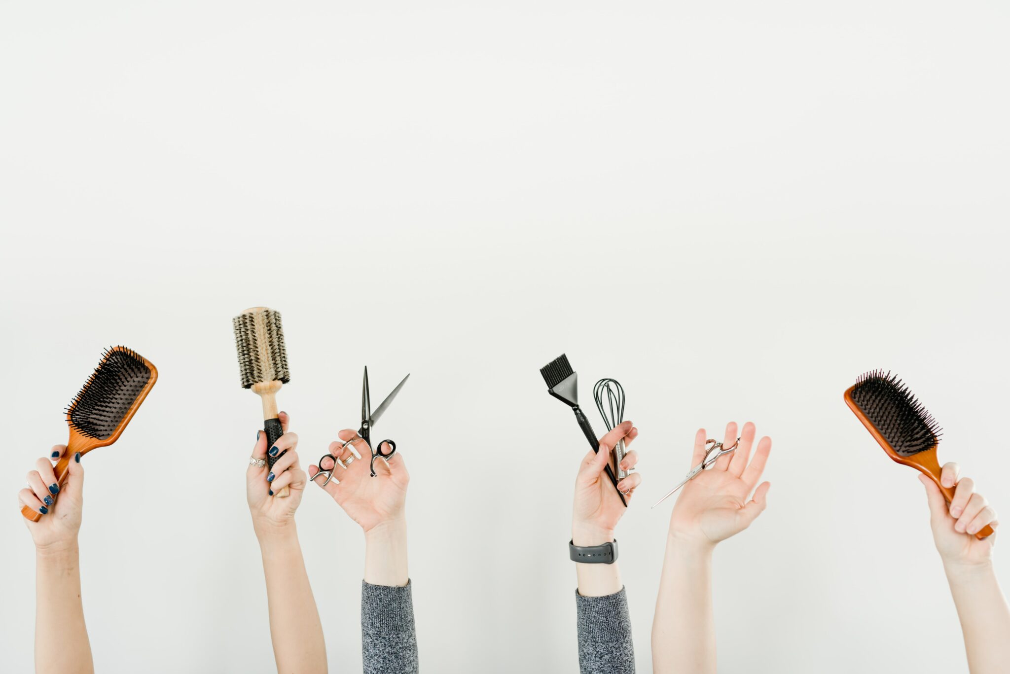 6 hands only visible above the elbow holding various hairdressing tools for the page hairdresser bank transfer