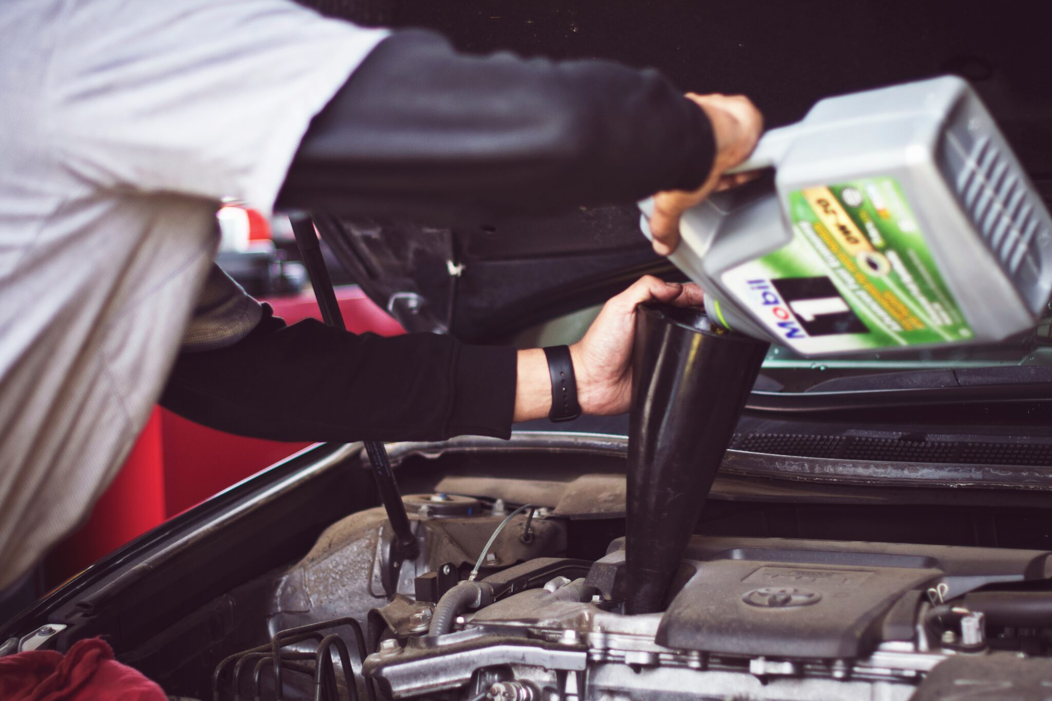 an image of a person filling a card with oil for the page collecting bank transfer payments as a motor trade business